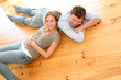© goodluz - Couple at home relaxing on the floor