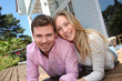 © goodluz - Portrait of smiling couple standing in front of house