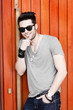 © matusciac - sexy man posing outdoors with sunglasses