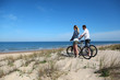 © goodluz - Couple with bicycles looking at the ocean