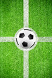 Soccer ball on a line of artificial grass field texture
