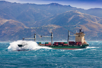 Loaded container freight ship in stormy sea