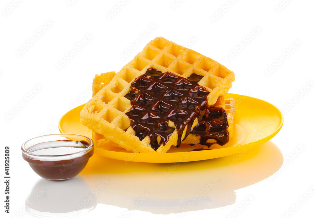 Tasty waffles with chocolate on plate isolated on white