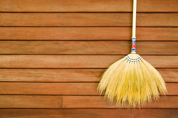 broom on wooden wall