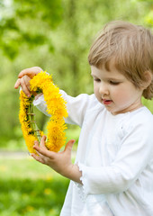 Adorable little girl holding flower chaplet