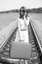 Young Fashion Girl With Suitcase At Railways.