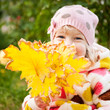 © Sunny studio - Child hidden behind yellow leaves
