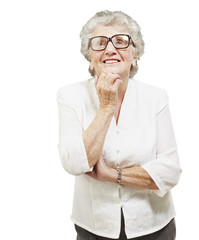 portrait of senior woman thinking and looking up over white back