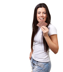 portrait of young woman eating chocolate bar against a white bac