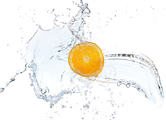 Orange slice falling and splashing into clear water.