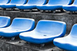 blue ordered rubber seats in a sports track field