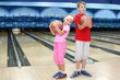 © Pavel Losevsky - Smiling brother and sister hold balls in bowling club