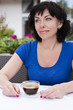 © Karyna Chekaryova - Beautiful woman in street cafe ,with cup