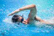 © lightpoet - Young man swimming the front crawl in a pool