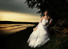 The Bride Admiring The Sunset At The Riverside