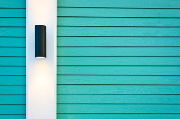 Lamp on green wood texture wall