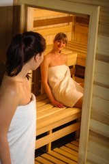 Wall Mural - Women at sauna entering wrapped in towel