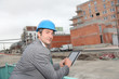 © goodluz - Architect using electronic tablet on building site