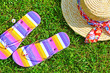 Colourful flip flops and a straw hat