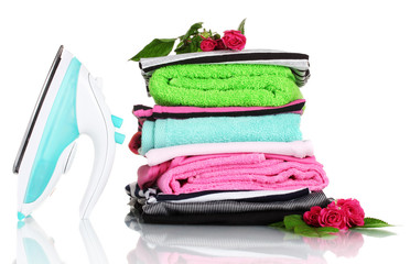 Sticker - Pile of colorful clothes and electric iron with roses isolated