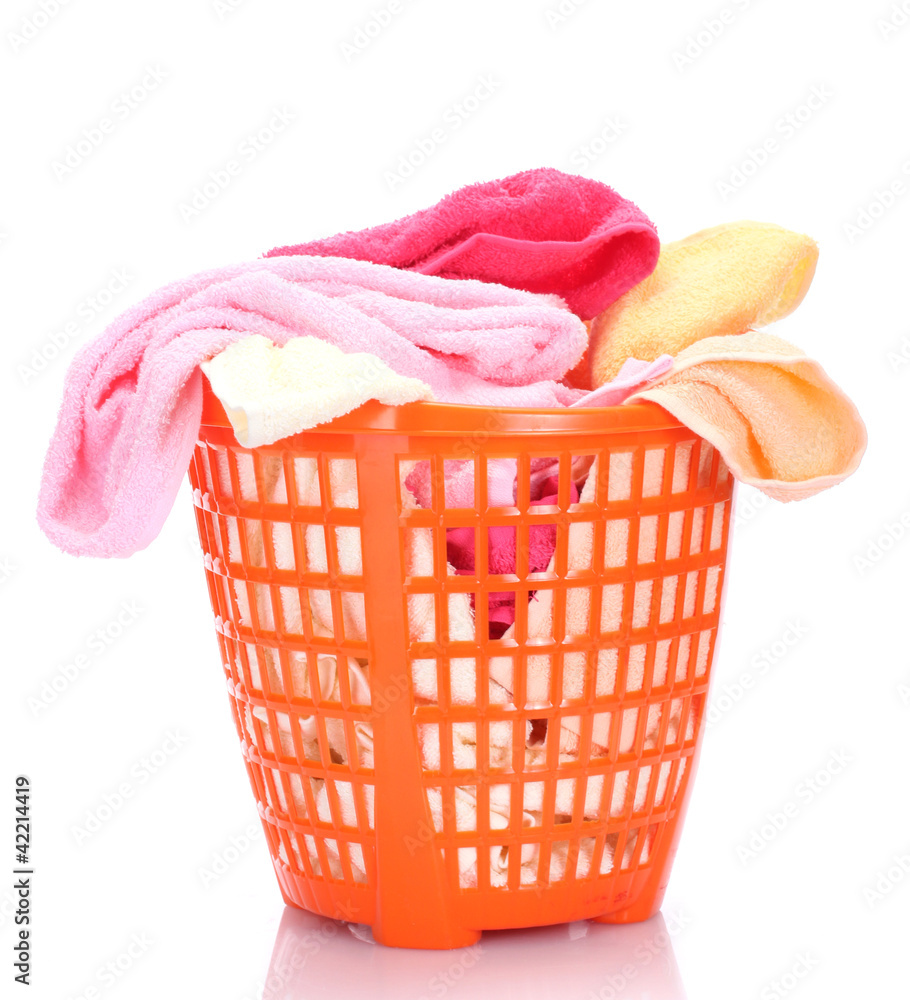 Plastic basket with bright towels isolated on white