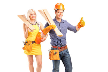 Wall Mural - A smiling carpenter team of man and woman holding sills