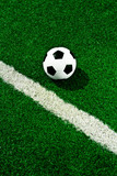Fototapeta  - Soccer ball on green grass