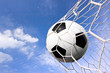 close-up of a soccer ball (football) going into the back of the