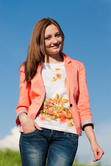 Poster - Happy beautiful woman smiling against blue sky