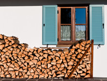 Stack Of Logs In Front Of The Window