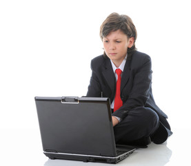 Wall Mural - boy in business suit sitting in front of computer