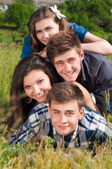 Sticker - happy young people two boys and two girls outdoors