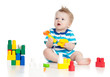 © Oksana Kuzmina - cheerful child boy playing with construction set over white back