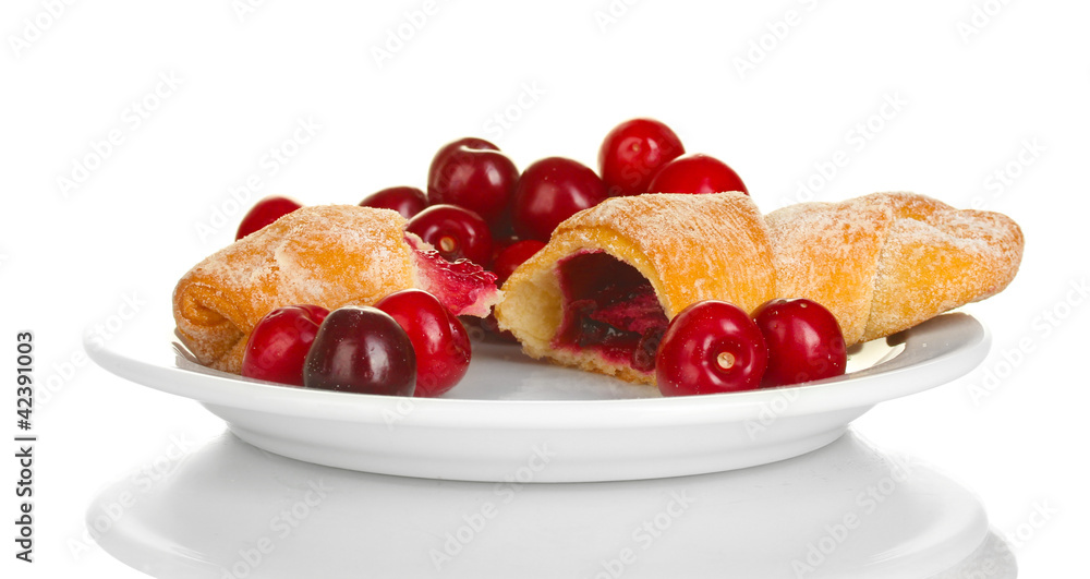 white plate with croissant and cherry isolated on white