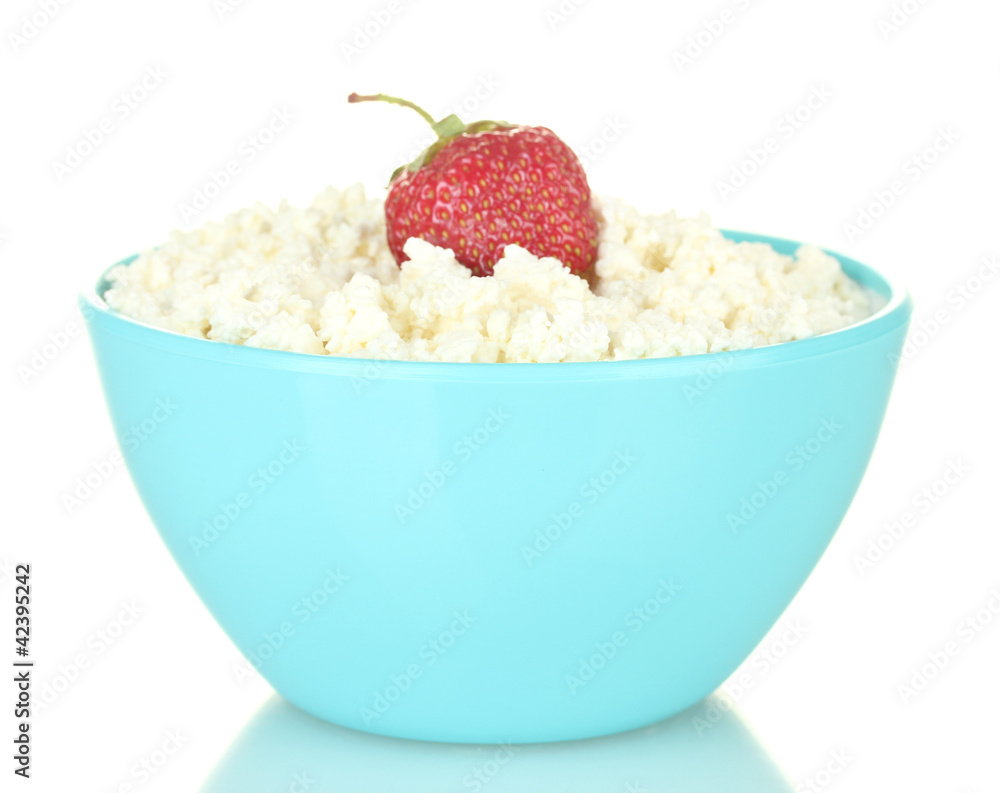 cottage cheese with strawberry in blue bowl isolated on white