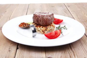 Wall Mural - grilled beef fillet pieces on noodles with tomatoes and dry spic