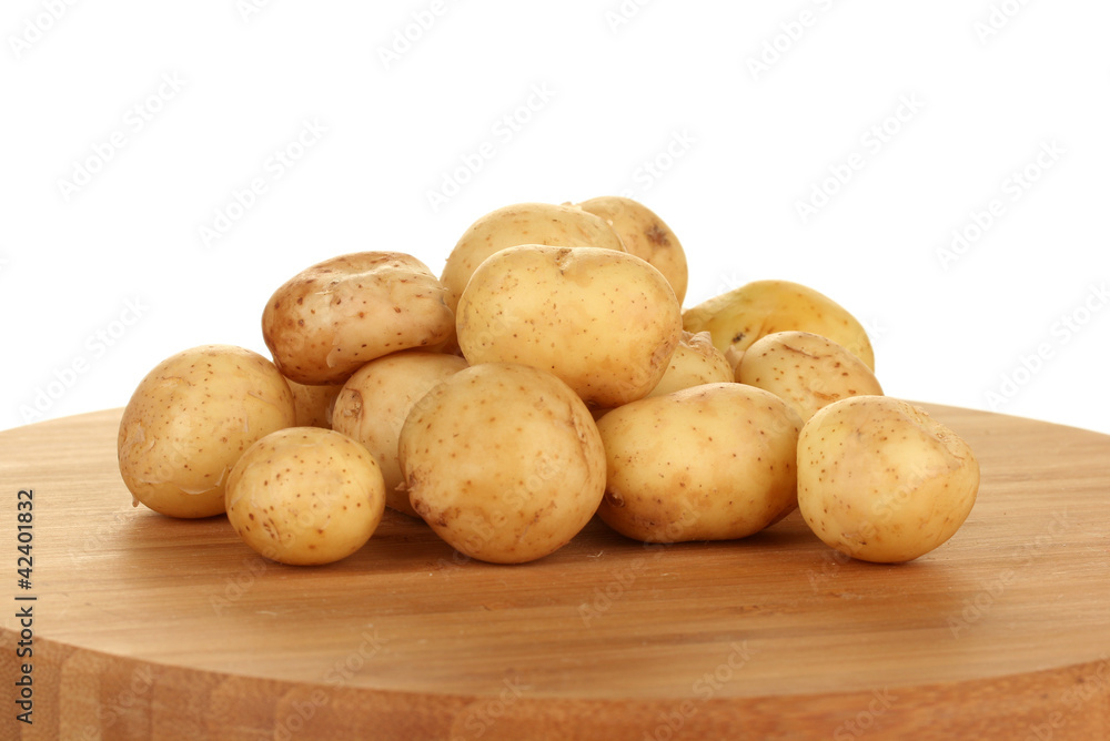 young potatoes on a cutting board on white background close-up