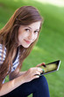 © pikselstock - Woman using digital tablet outdoors