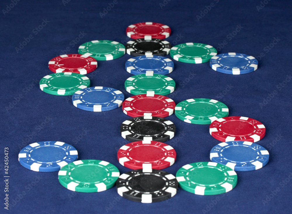 poker chips in the form of dollars on a blue table