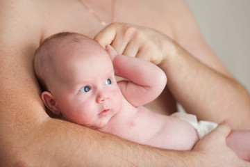 happy father holds his adorable 1 months old baby