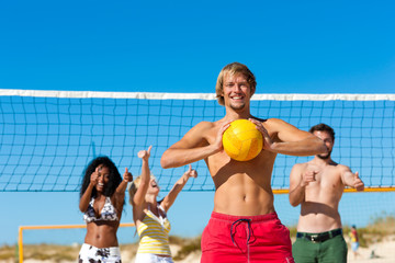 Friends playing beach volleyball