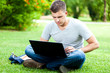 © Minerva Studio - Student with a laptop in the park