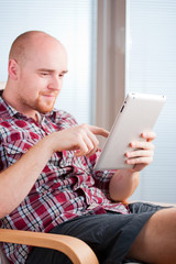 Focused man working and playing with tablet computer (lots of co