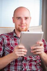 Focused man working and playing with tablet computer (lots of co