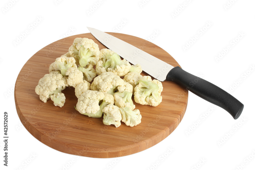 Fresh cauliflower and knife on cutting board isolated on white
