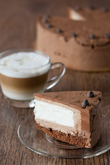 Wall Mural - Triple chocolate cake on a wooden table