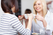 © contrastwerkstatt - zwei freundinnen reden im café