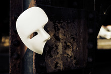 Masquerade - Phantom Of The Opera Mask On Rusty Bridge Column