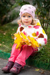 © Sunny studio - Child with bunch of yellow leaves
