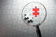 Search For Missing Puzzle Pieces With A Magnifying Glass.